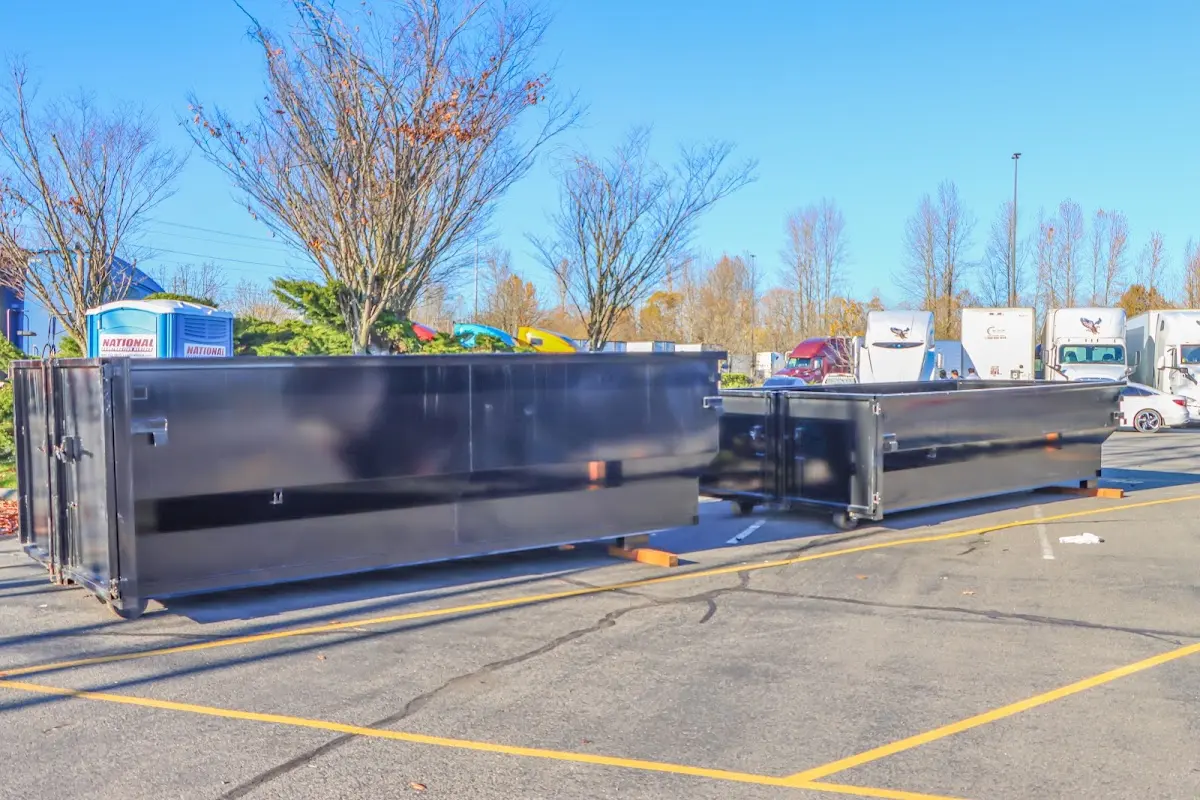 Professional dumpster rental service with roll-off container on residential driveway in Egg Harbor